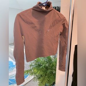 Semi-cropped, laser cut top by Fabletics. Never worn. NWT